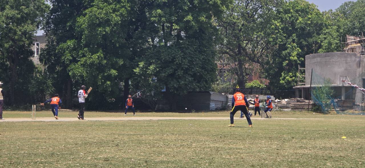Fielders and batter during a cricket match at GNPS Cricket Ground