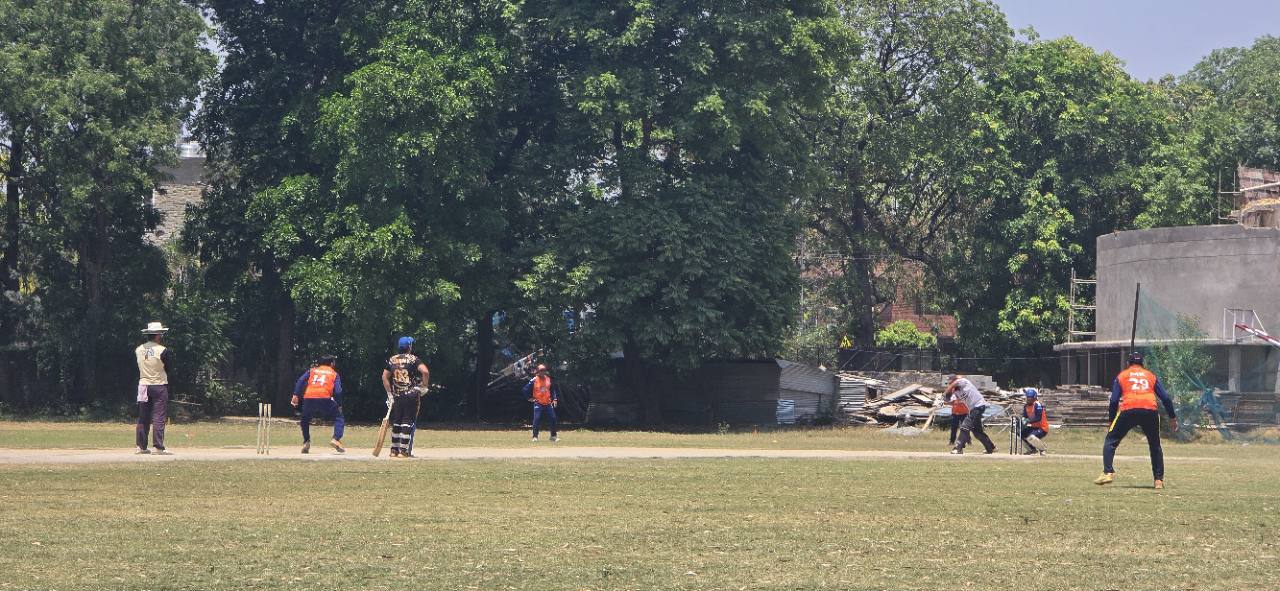 Players in a live cricket match at GNPS Cricket Ground